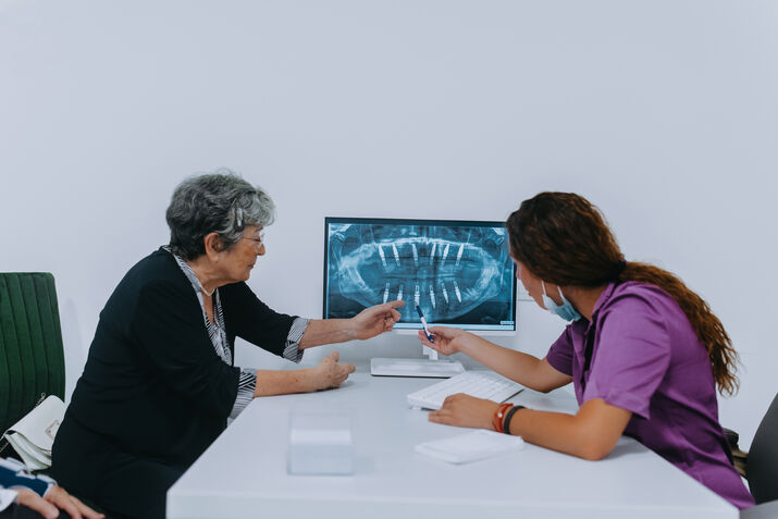 Dentist examining a dental X-ray with the patient