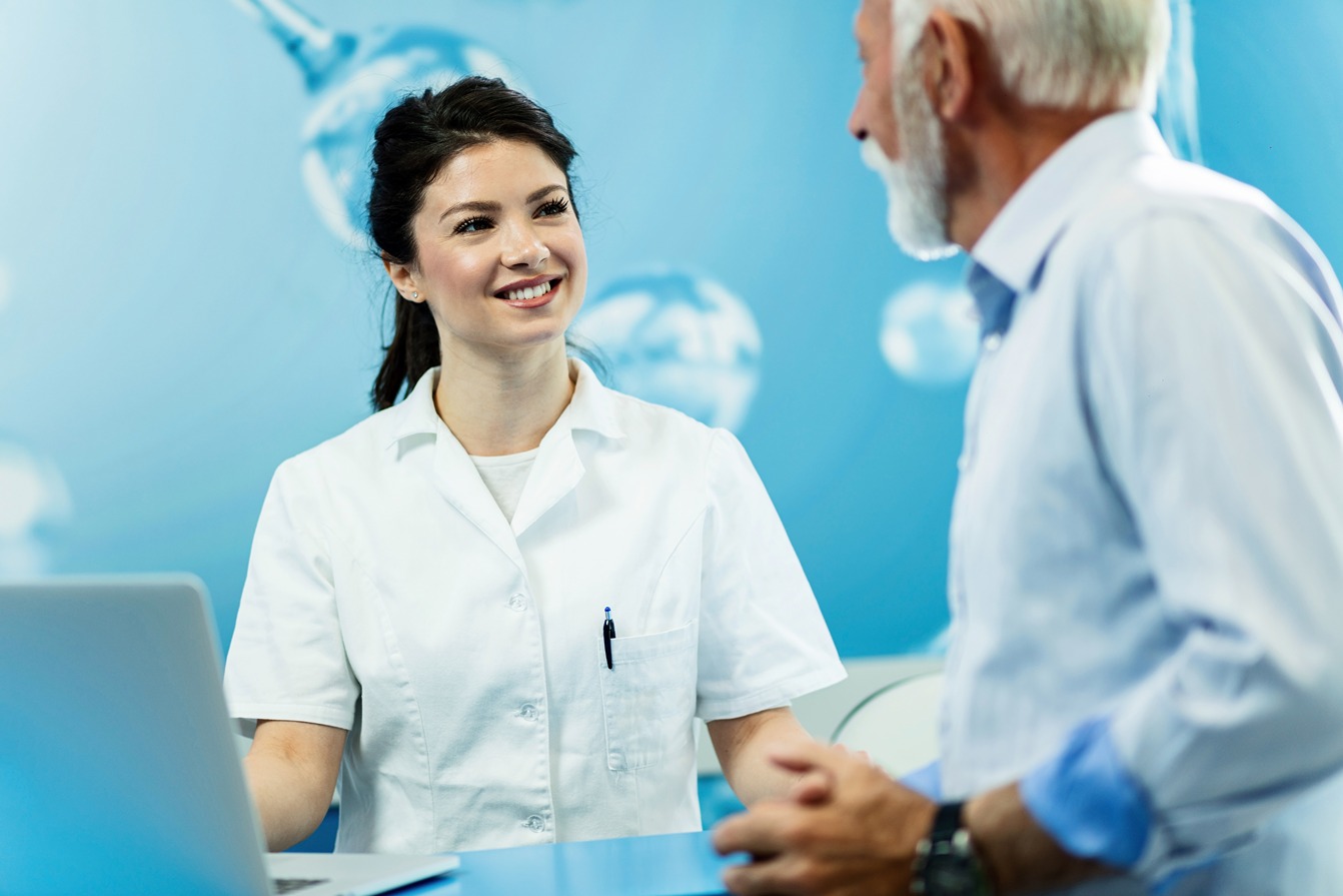 Senior patient consulting with a dental professional.